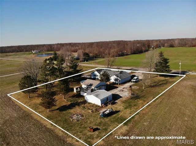 Aerial view of sparsely populated area featuring property boundaries highlighted