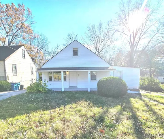 View of front of house featuring covered porch and a front lawn