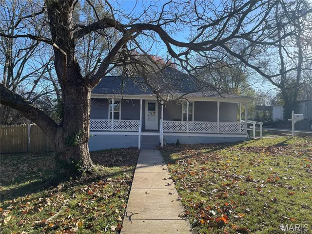 Bungalow-style home with covered porch, crawl space, and a shingled roof