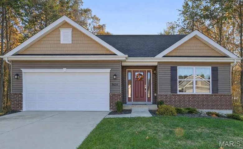 Beautiful home with deck overlooking partially wooded lot.