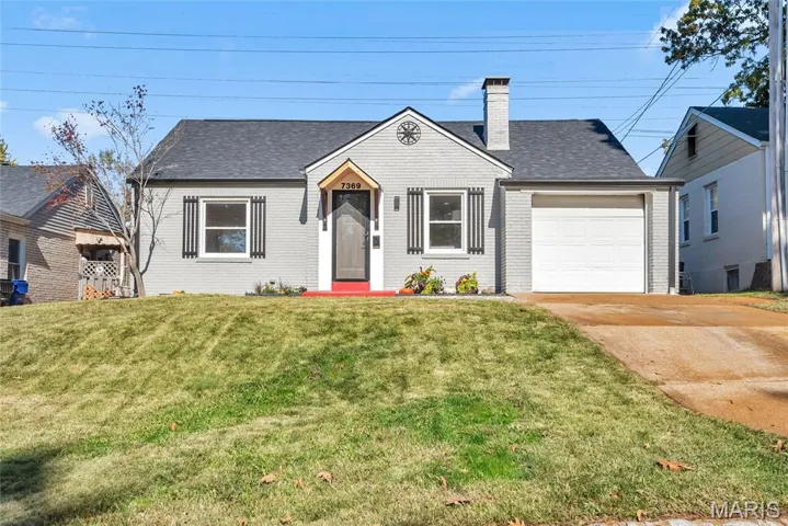 Cape cod bungalow-style home featuring a NEW shingled roof, brick siding and an attached garage