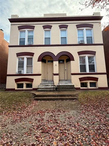 View of front of home featuring brick siding and covered porch