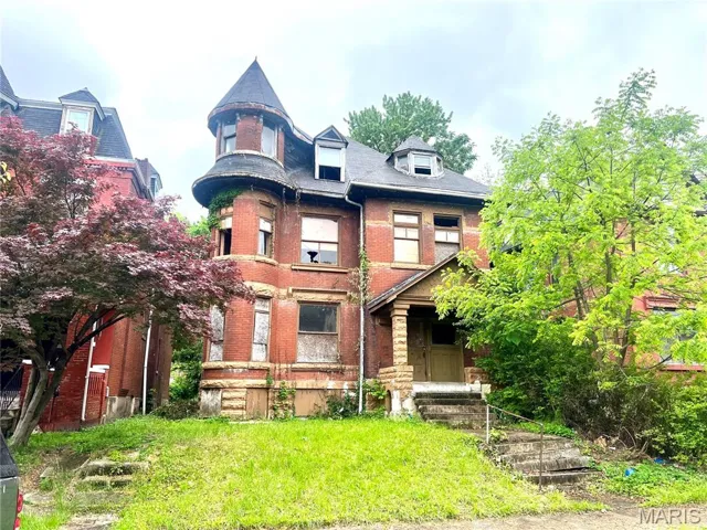 Victorian house featuring brick siding