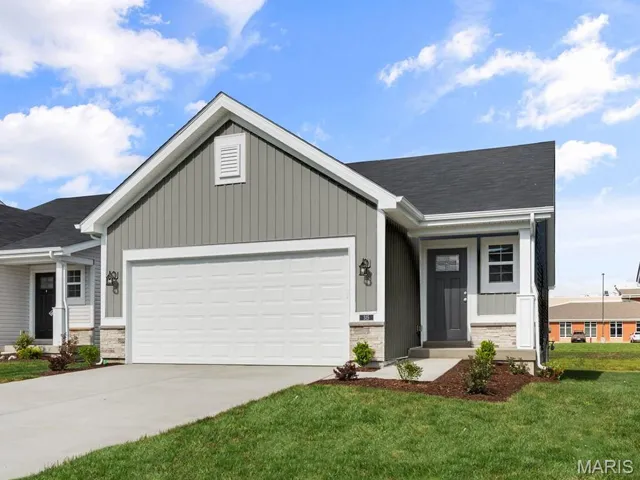 Ranch-style house with a garage, concrete driveway, a porch, and board and batten siding