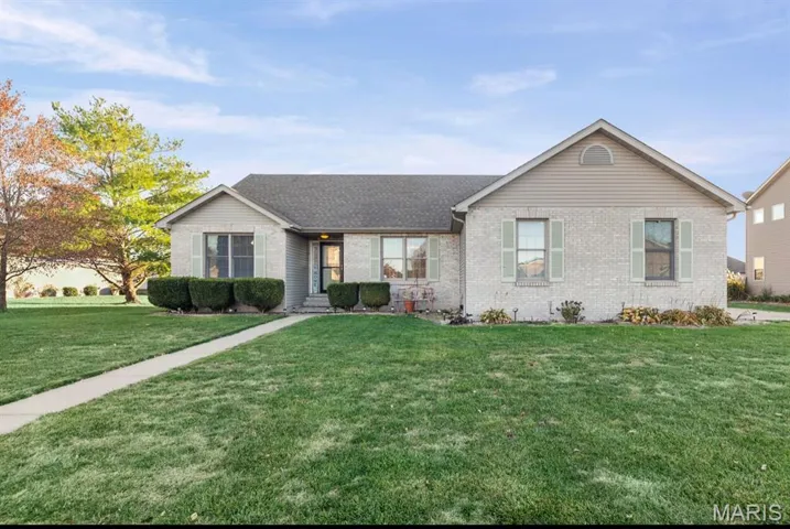 Single story home featuring a front yard, brick siding, and roof with shingles