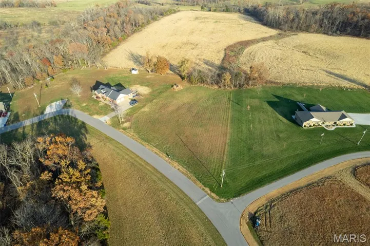 Aerial view of property and surrounding area featuring rural landscape