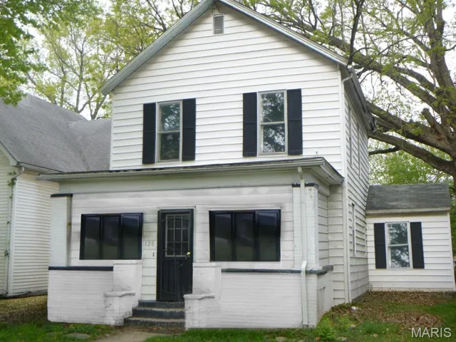 View of front of house featuring entry steps and a shingled roof