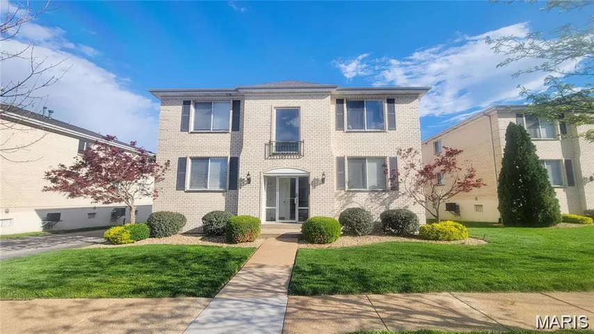 View of front of house featuring a front yard and brick siding
