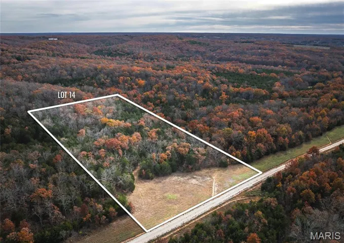 Aerial view of property's location featuring property boundaries highlighted and a forest