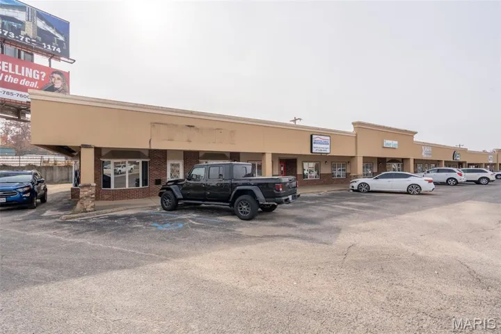 View of commercial property featuring uncovered parking