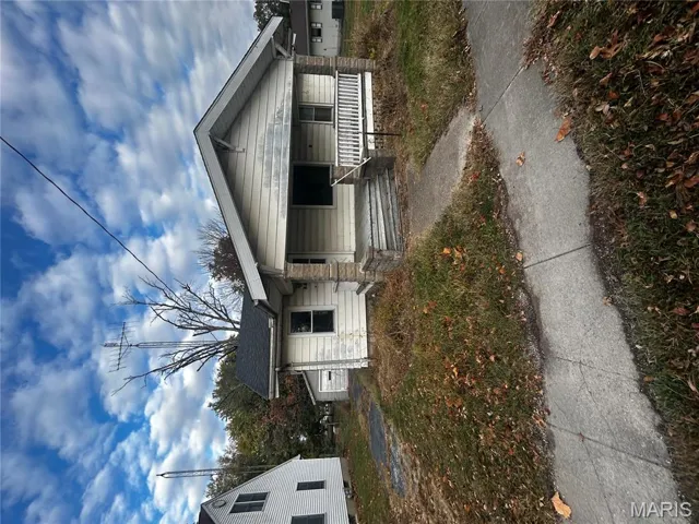 Bungalow-style house featuring covered porch and a garage
