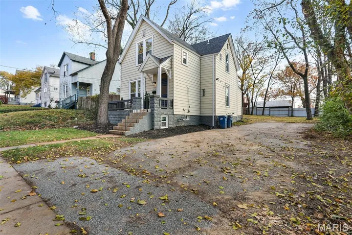 View of property exterior with a shingled roof