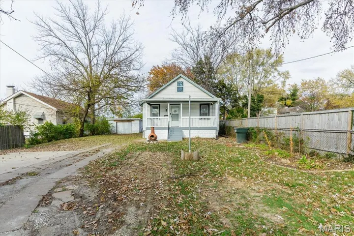 View of front facade with covered porch and a garage