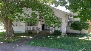 View of front of home with a front yard and a wooden deck