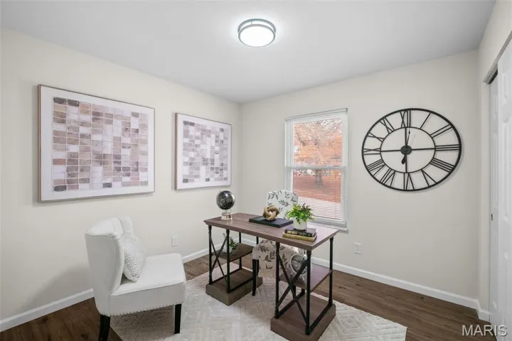 Office space featuring dark wood finished floors and baseboards