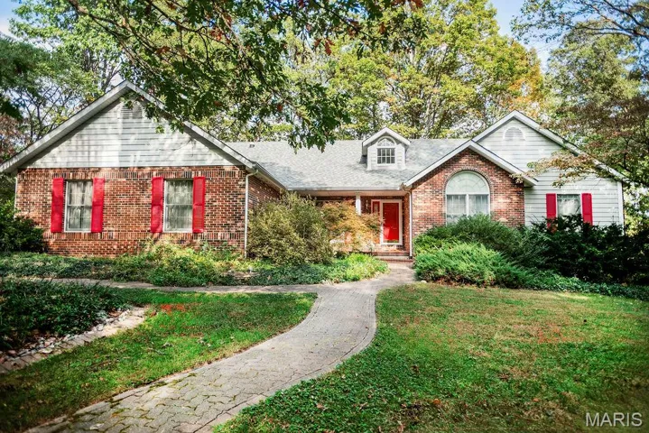 View of front of home featuring brick siding, a front lawn, and a shingled roof