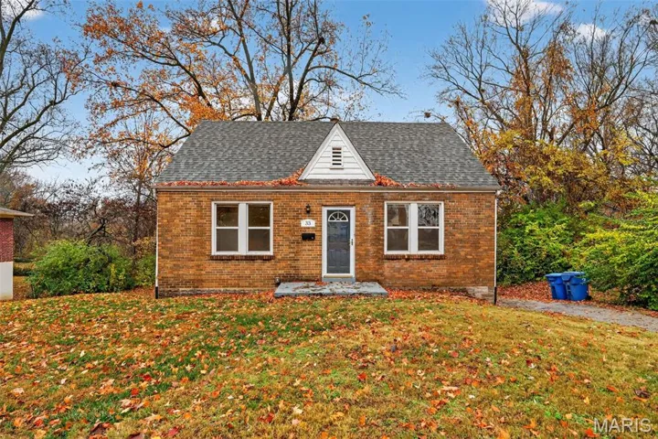 Bungalow-style house featuring a front yard, brick siding, and a shingled roof