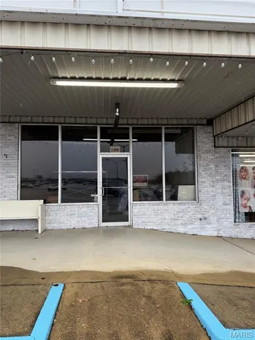 Entrance to property featuring brick siding
