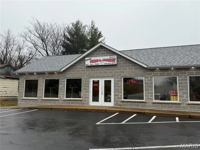 View of property with uncovered parking