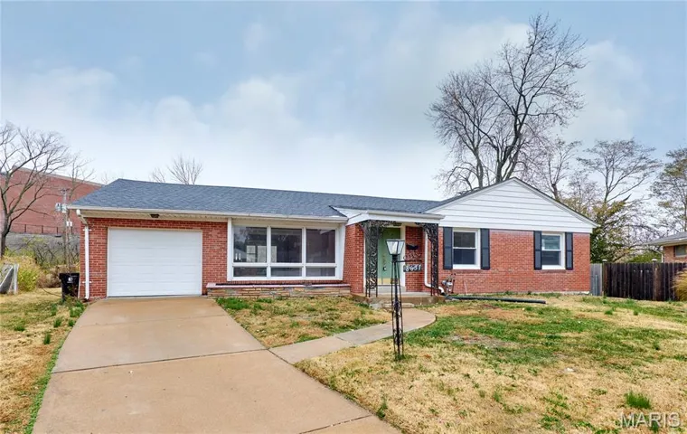 Ranch-style house featuring a shingled roof, brick siding, concrete driveway, and an attached garage