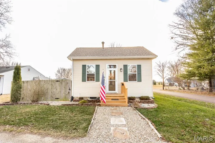 Bungalow-style house featuring roof with shingles