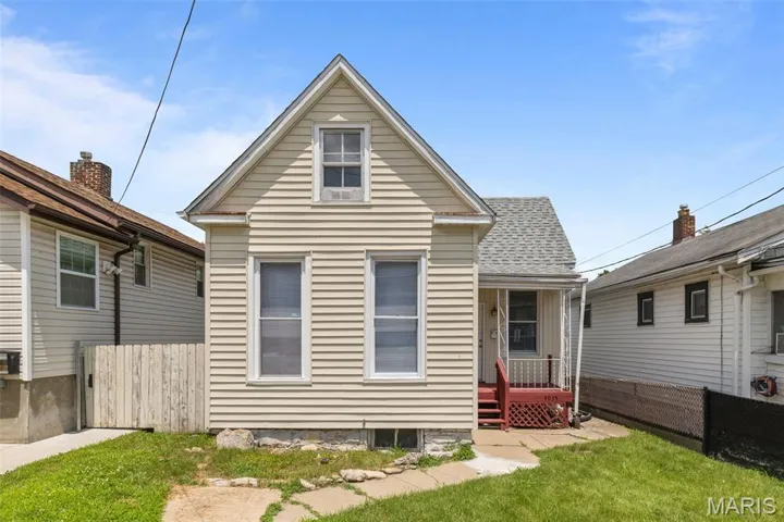 Rear view of property featuring roof with shingles