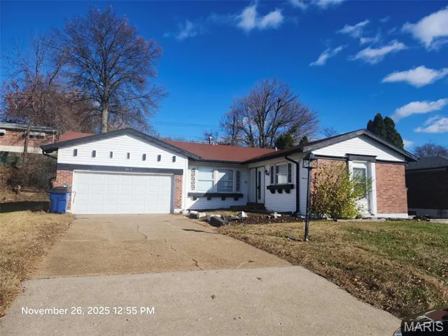 Single story home with driveway, brick siding, a garage, and a front lawn