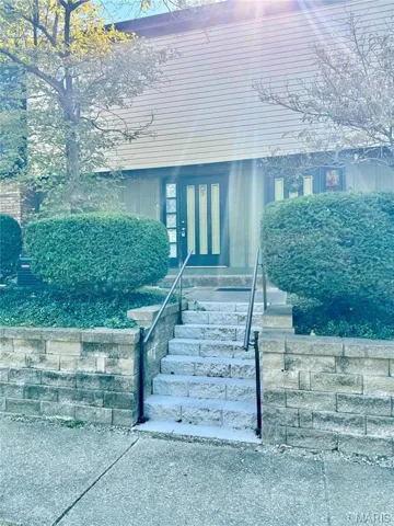 View of exterior entry with a porch