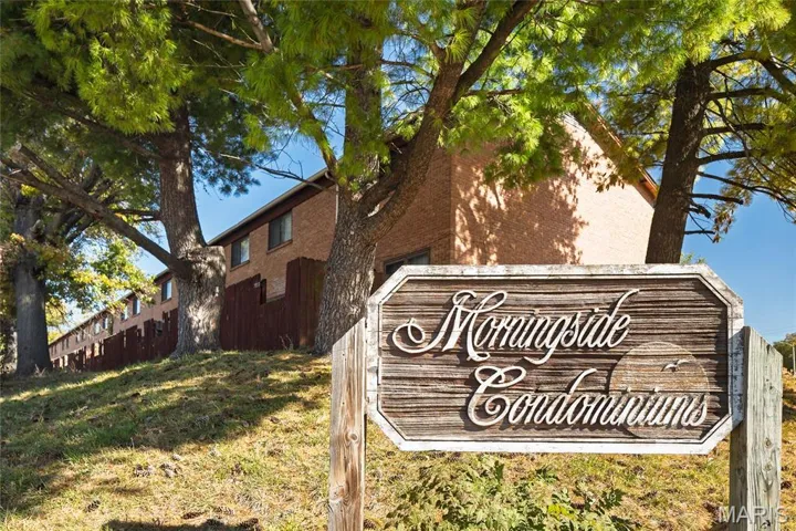 Community / neighborhood sign with a yard