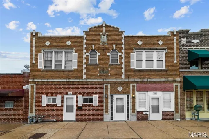 Traditional-style house featuring brick siding