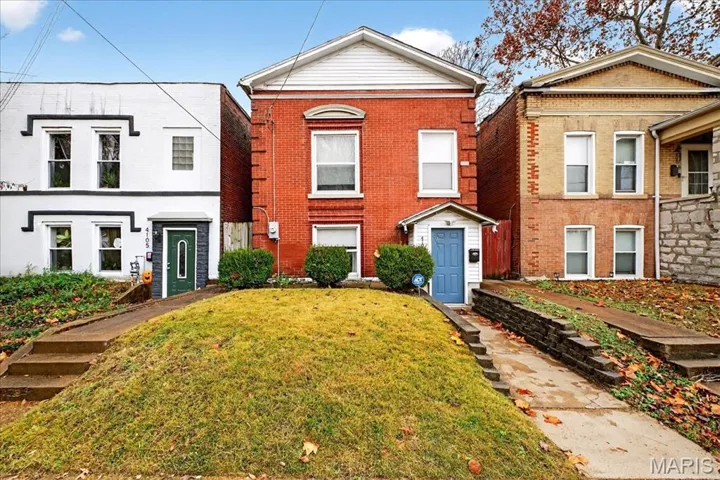 View of front of house featuring brick siding and a front yard