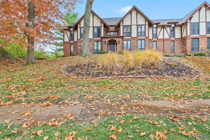 Tudor home with stucco siding and brick siding