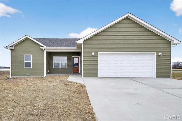 Ranch-style home featuring driveway, a garage, a porch, and a shingled roof