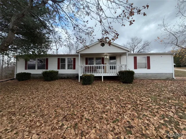 Ranch-style home featuring a porch