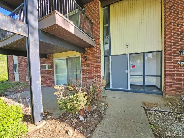 Entrance to property with brick siding