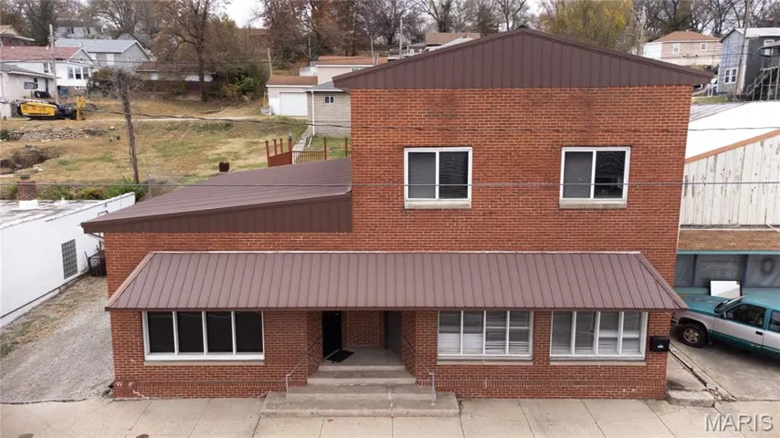 View of front of house featuring brick siding and a residential view