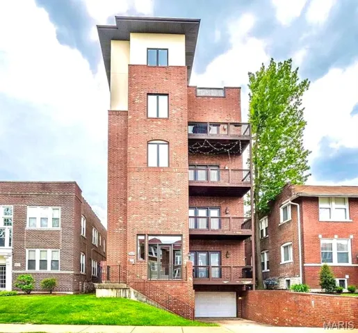 View of apartment building / complex with a garage