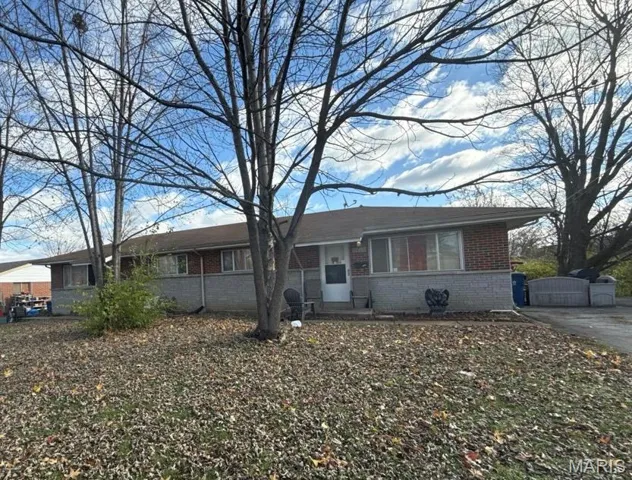 Single story home with brick siding and a gate