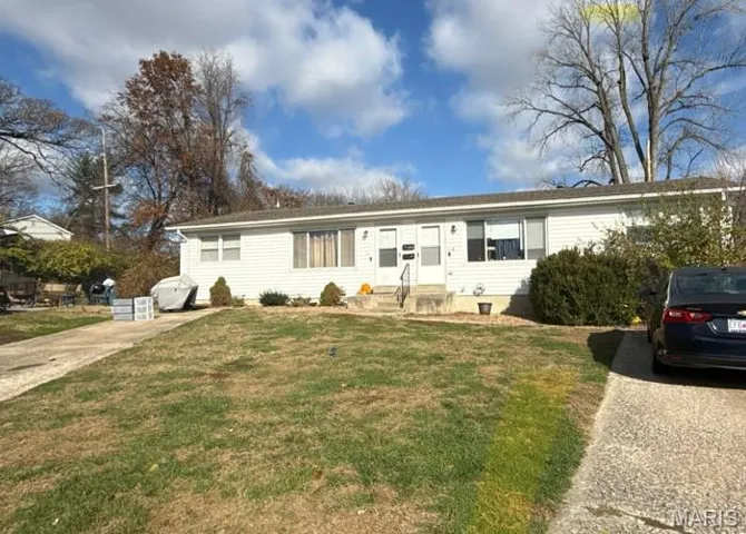 Single story home featuring a front yard