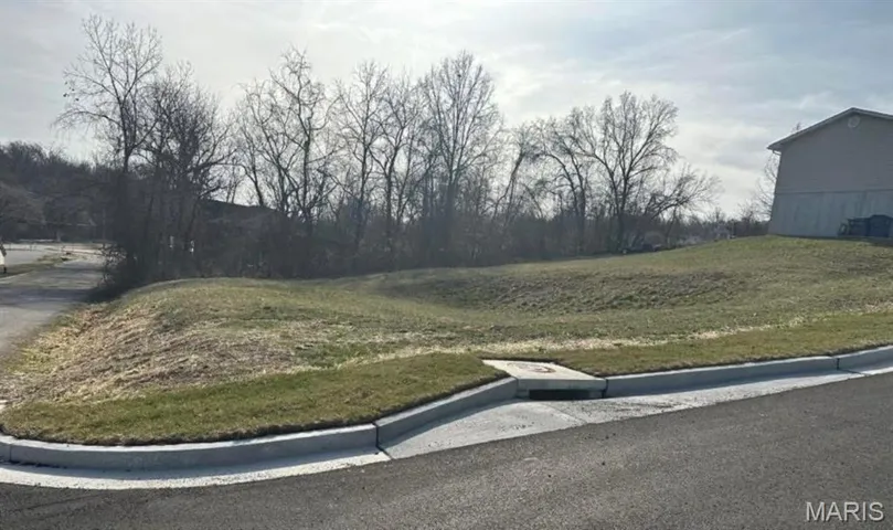 View of asphalt street featuring curbs