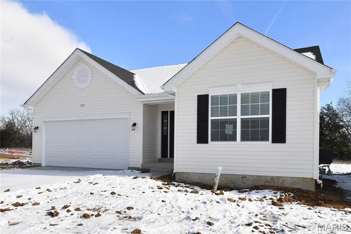 View of front of property with a garage