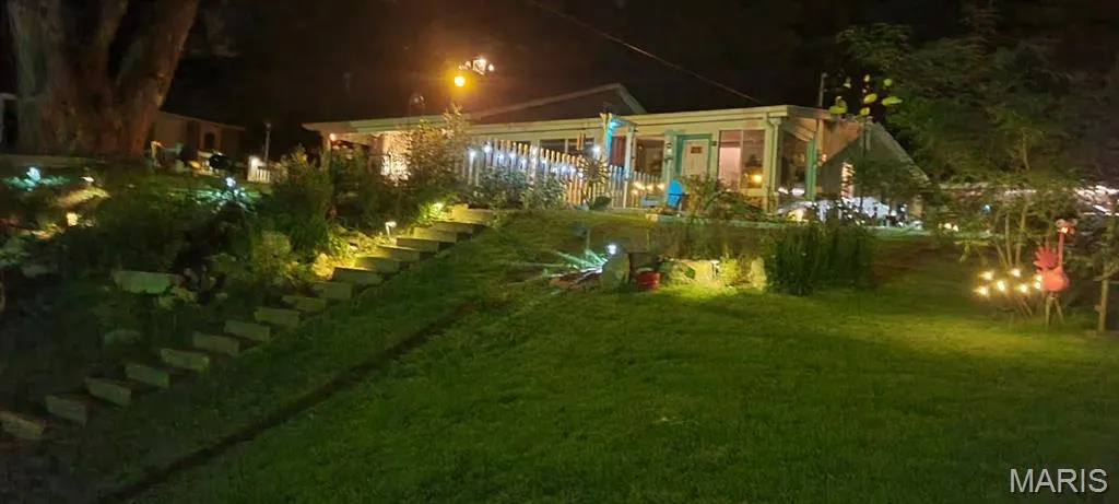 Yard at night with a lawn and stairway