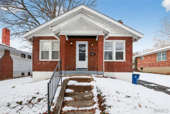 View of front of house with brick siding and covered porch