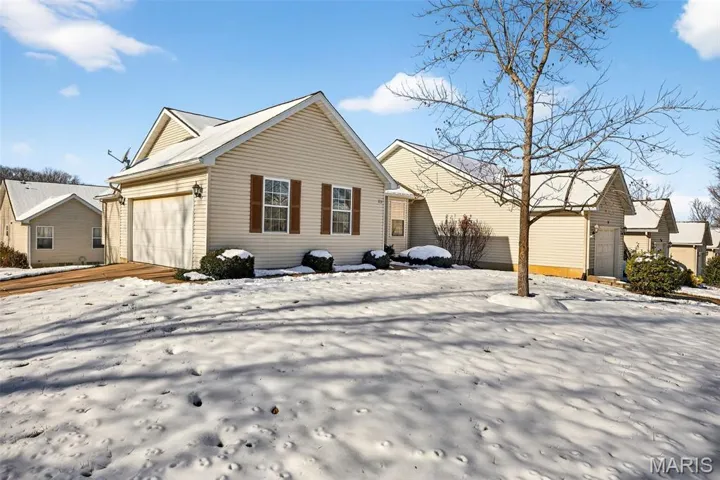 View of front of property with a garage and driveway