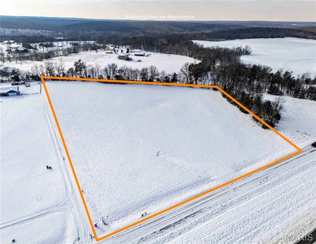 Snowy aerial view featuring property boundaries highlighted