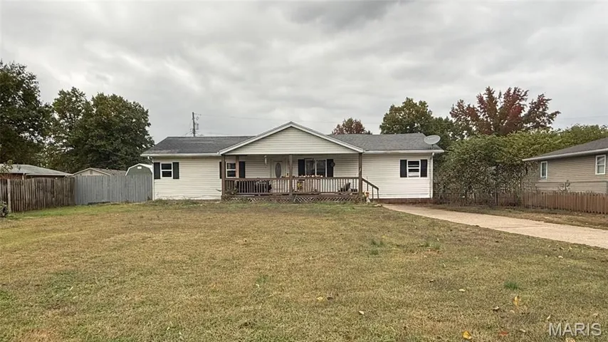 Ranch-style home featuring covered porch and driveway