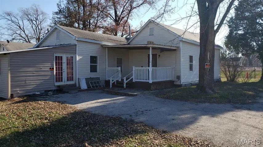Back of property featuring french doors and a porch