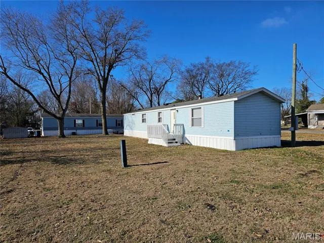 Rear view of property with a yard