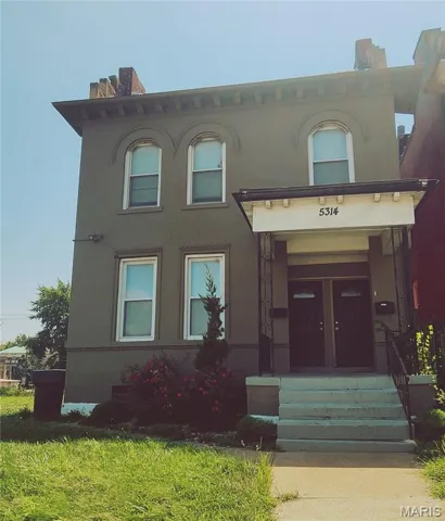 View of front of home with french doors and stucco siding