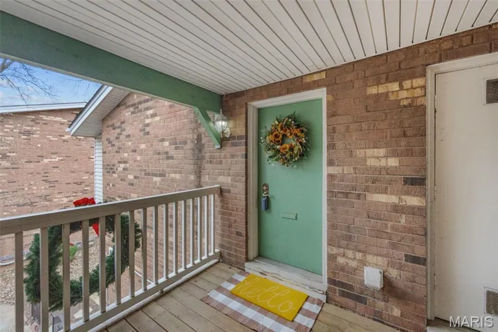 Doorway to property featuring brick siding